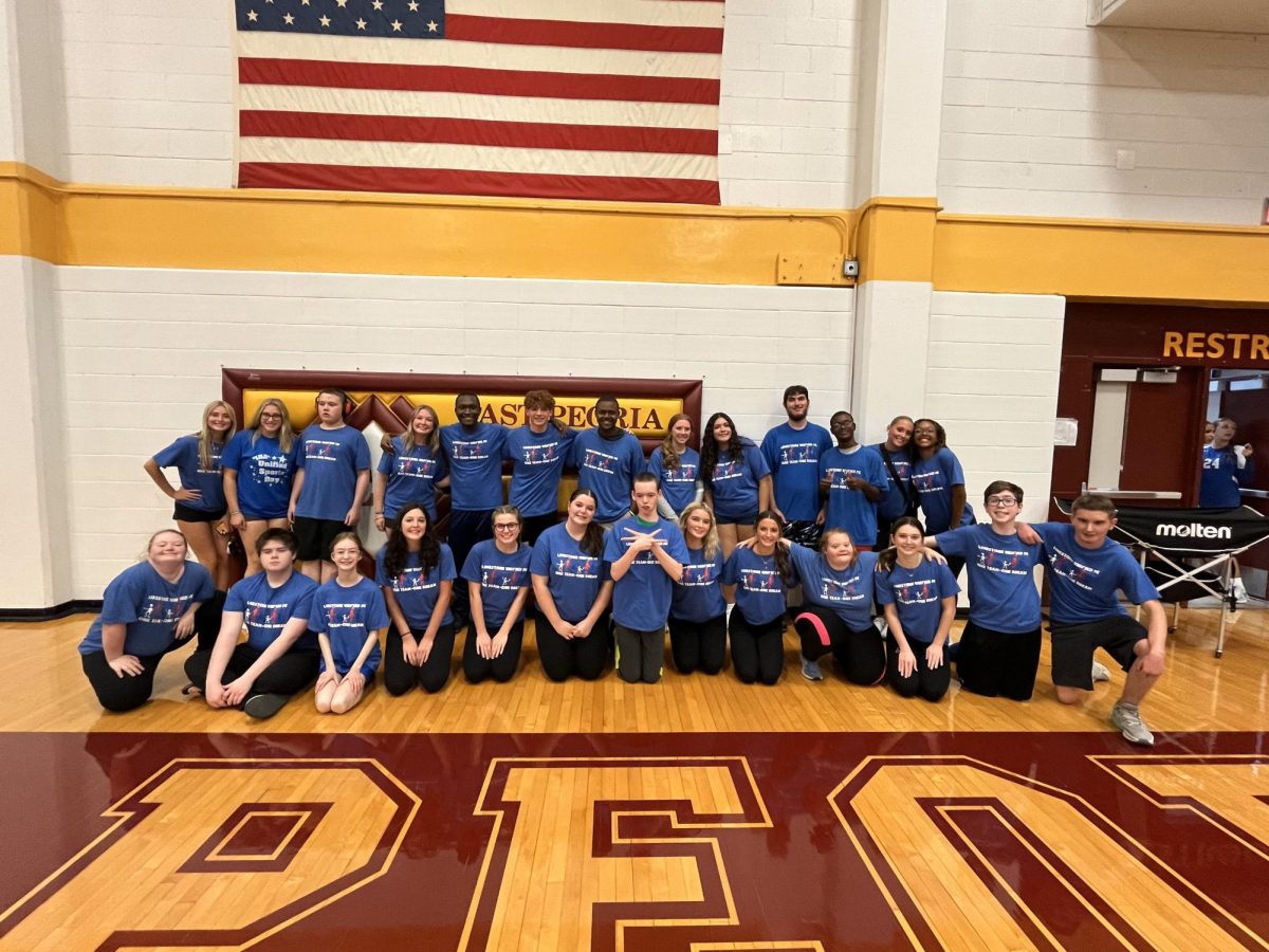 Unified volleyball poses for a picture after their game against East Peoria.