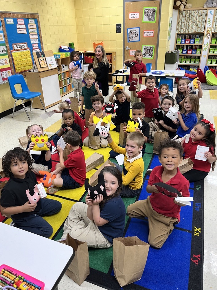 A class of students at Pleasant Hill enjoys their new stuffed monsters which were made by creative fashion students.